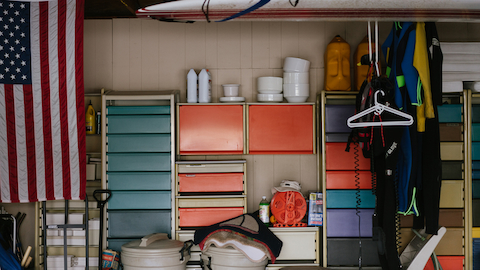 Garage in designer Jack Kelley’s home with Co/Struc system and multicolored storage drawers, USA flag on the right.