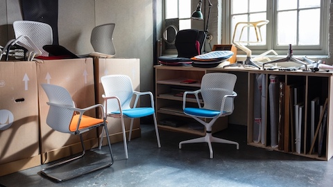 Three models from the Keyn Chair Group in a studio that also contains several Keyn components. Select to go to an interview with designers from forpeople.