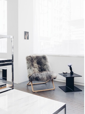 A Scissor Chair placed next to an I Beam Table.