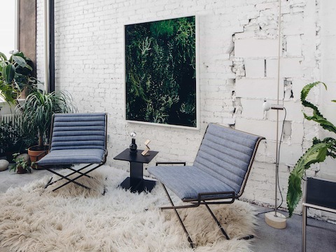 In the back reading room, two Sled Chairs upholstered in Japanese denim along with an I Beam Table.