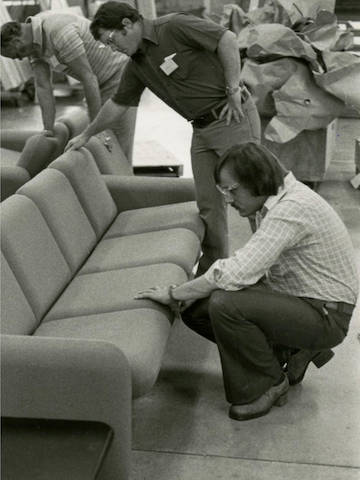 Black and white photo of product development team inspecting Wilkes Modular Sofas during manufacturing process. Black and white photo of product development team inspecting Wilkes Modular Sofas during manufacturing process.