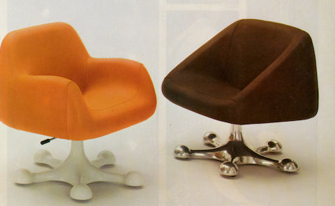 Two models of Wilkes Soft Seating facing each other at a quarter angle: one with orange upholstery and white base; the other with brown upholstery and chrome base.
