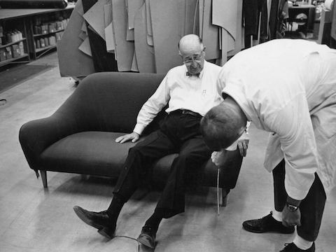 Herman Miller founder D.J. De Pree tries out a sofa while an employee takes measurements. Herman Miller founder D.J. De Pree tries out a sofa while an employee takes measurements.