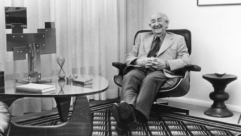 Herman Miller founder D.J. De Pree reclines in an Eames Lounge Chair. Select to read a WHY Magazine essay about De Pree.