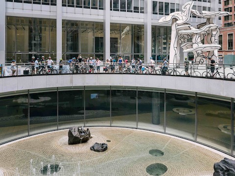 Bicyclists gather near Jean Dubuffet's Group of Four Trees sculpture in New York.