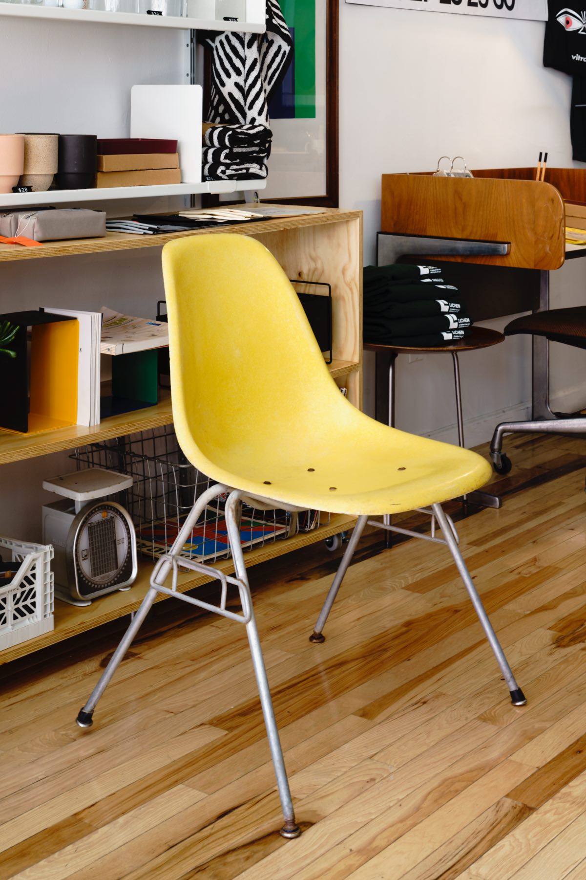 A vintage yellow Eames Shell Chair.