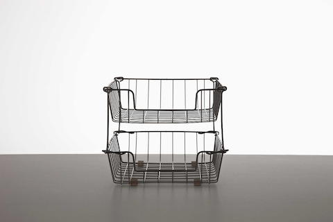 Black in-and-out wire baskets, one stacked on the other. Black in-and-out wire baskets, one stacked on the other.