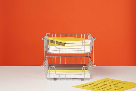 Silver in-and-out wire baskets containing notepads. Silver in-and-out wire baskets containing notepads.