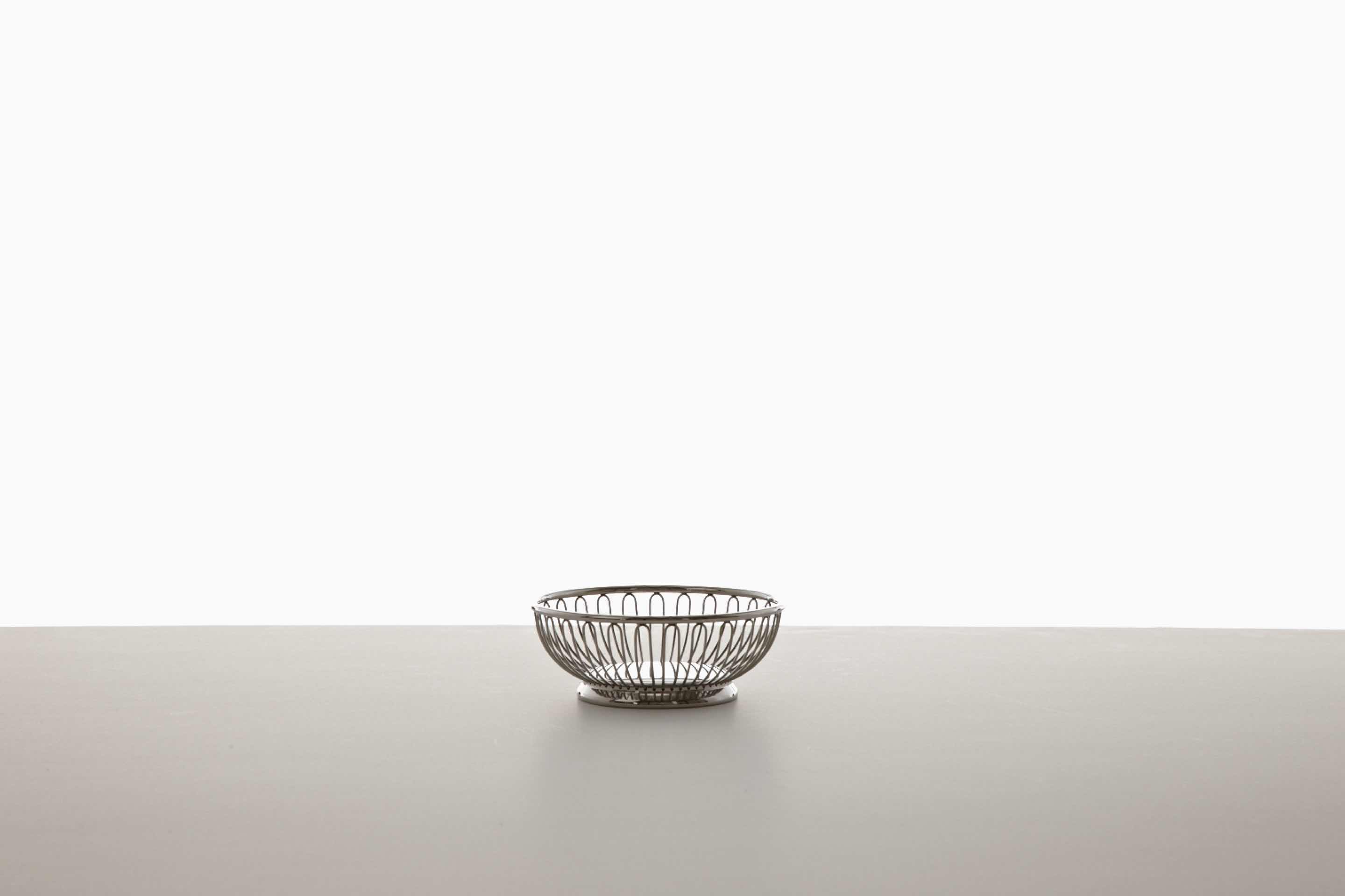A small, round, and empty wire basket.