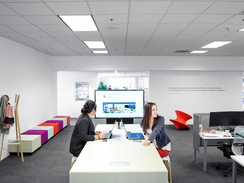 A long, bar-height bench next to the Education group's space is a favorite spot for quick huddles and brainstorming sessions. A long, bar-height bench next to the Education group's space is a favorite spot for quick huddles and brainstorming sessions.