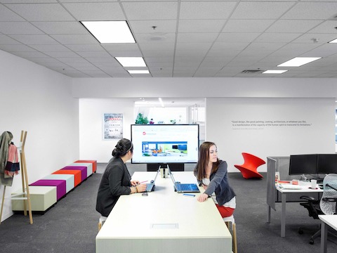 A long, bar-height bench next to the Education group's space is a favorite spot for quick huddles and brainstorming sessions. 