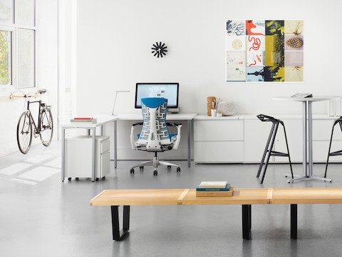 A blue Embody office chair in a white Canvas Office Landscape individual work area.